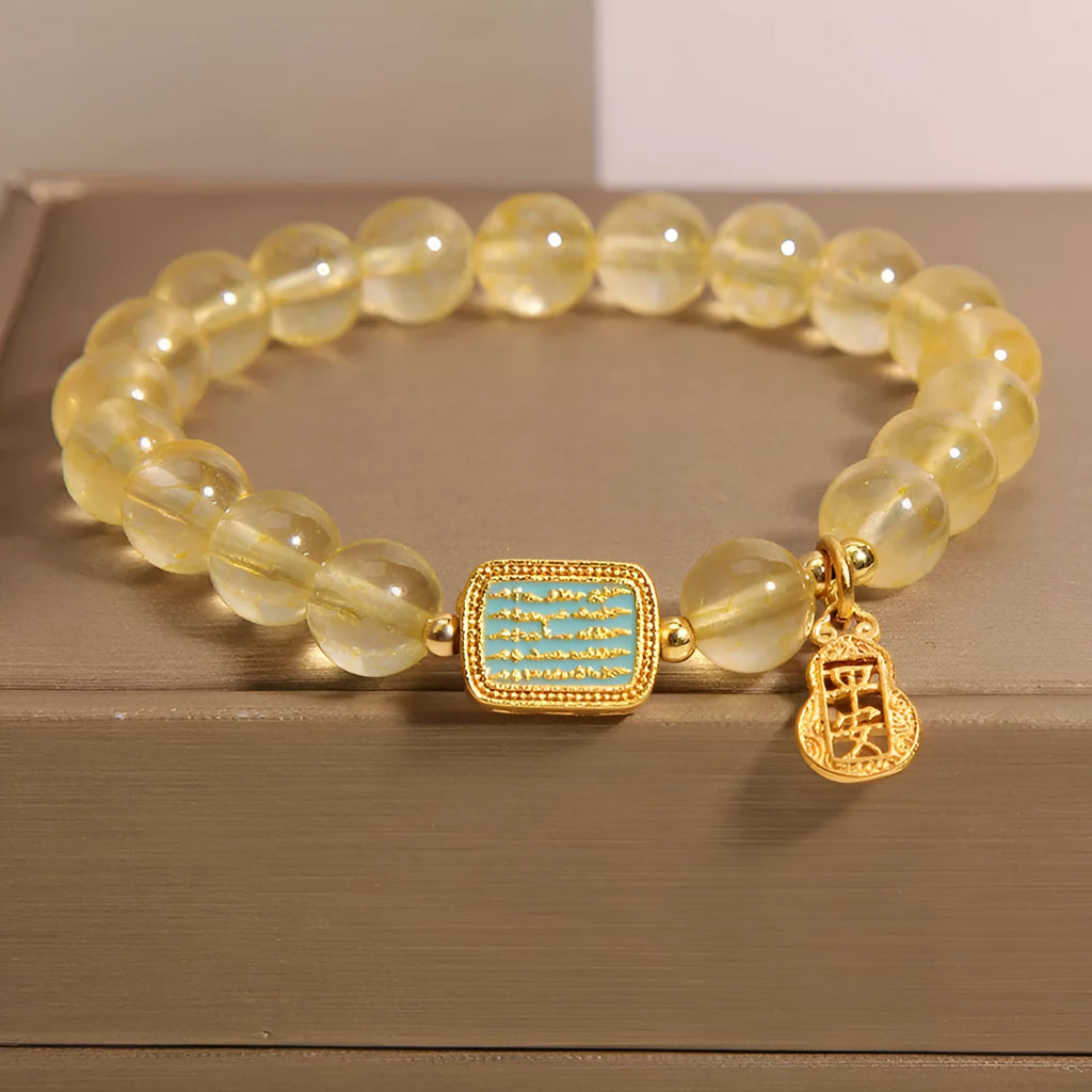 Natural citrine yellow crystal bracelet for women with rhinestone accents on a white background