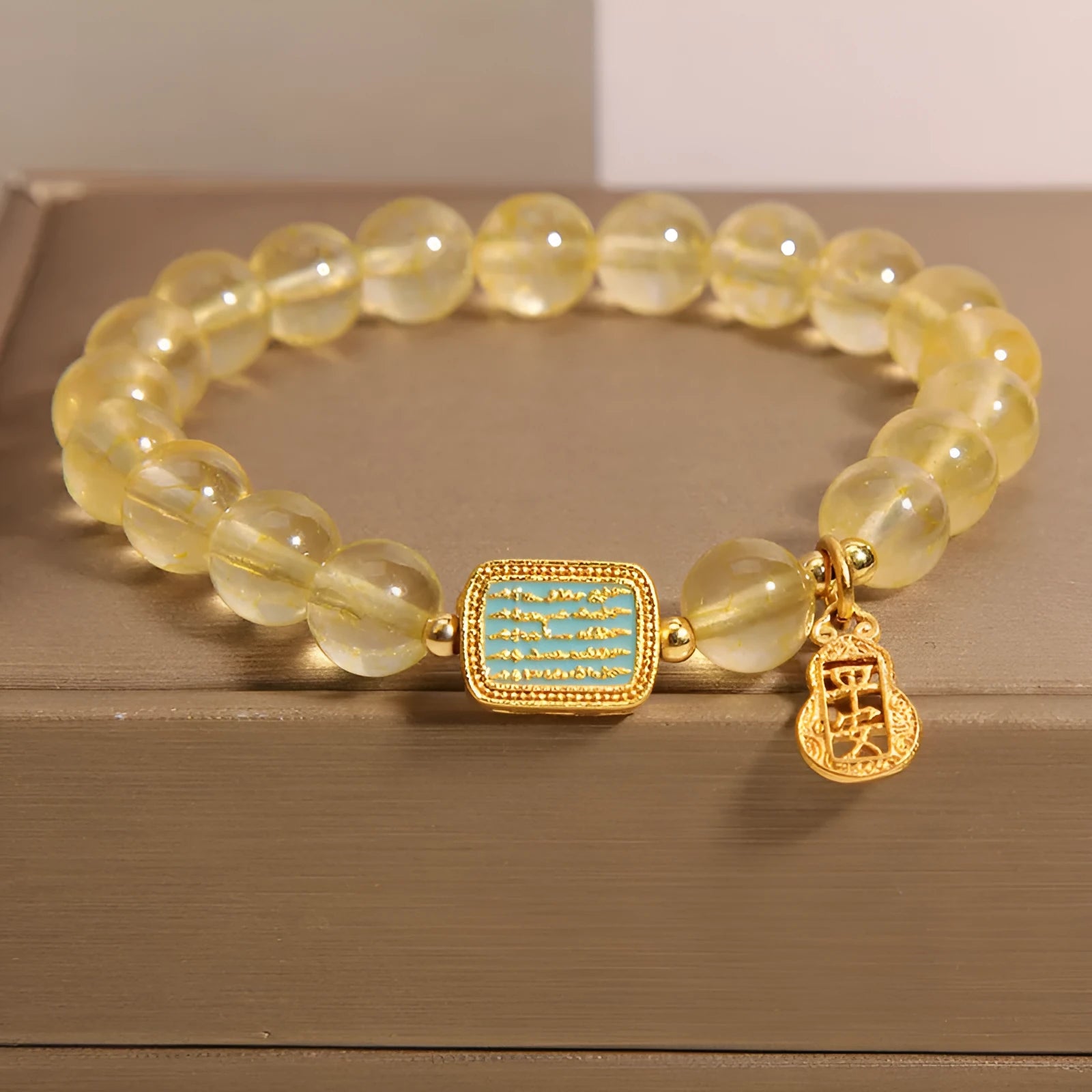 Natural citrine yellow crystal bracelet for women with rhinestone accents on a white background