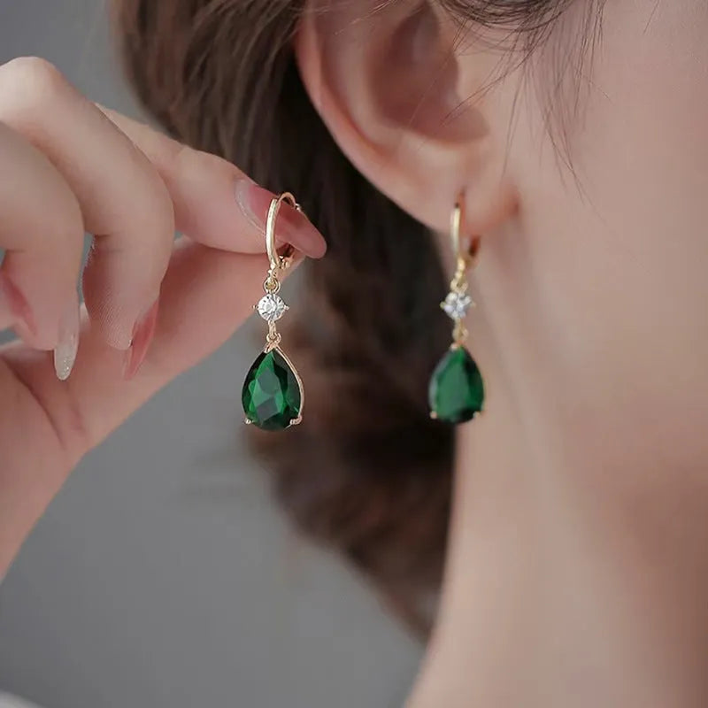 A pair of green geometric teardrop earrings made from alloy metal.