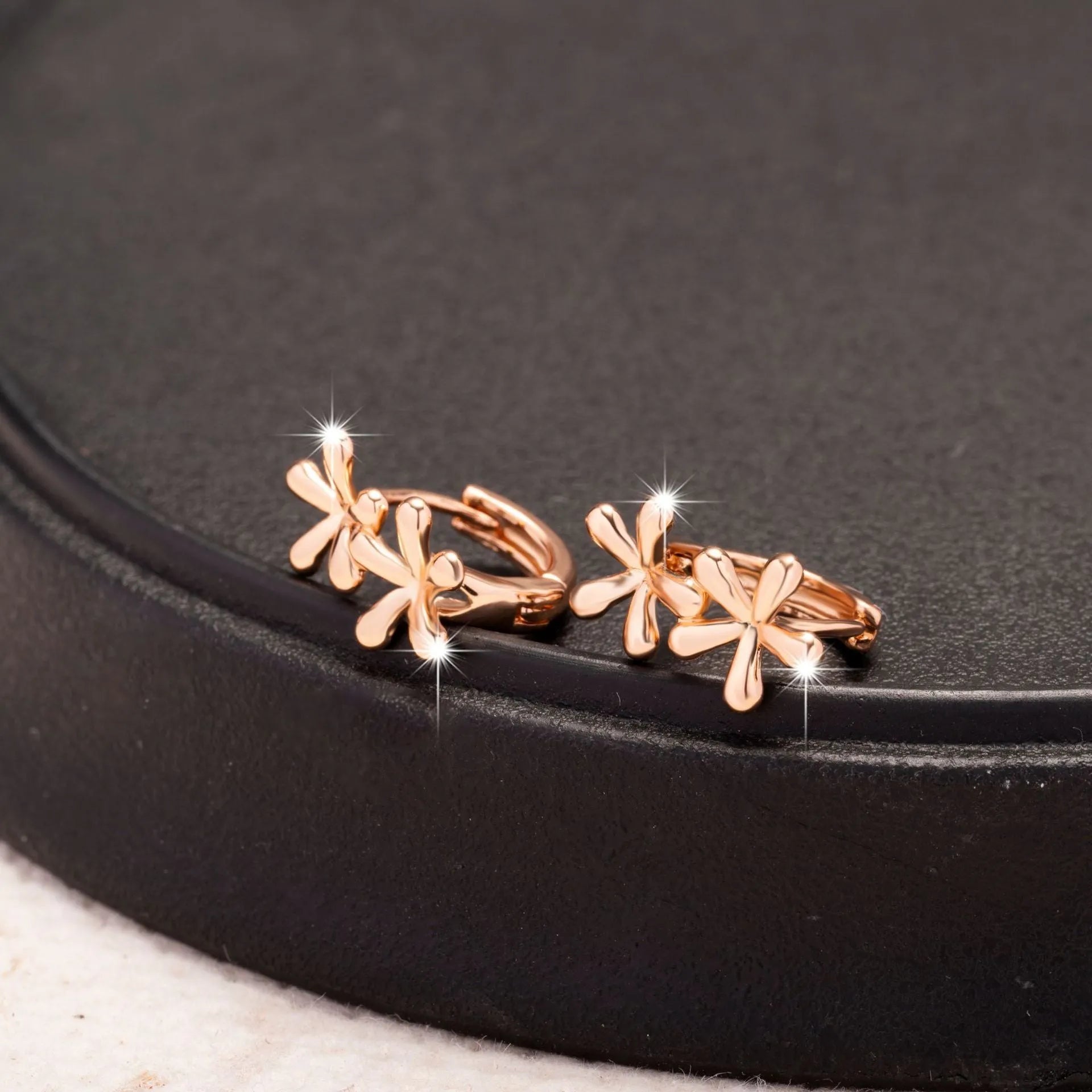 Circular rose gold electroplated earrings with waterdrop flower design for women