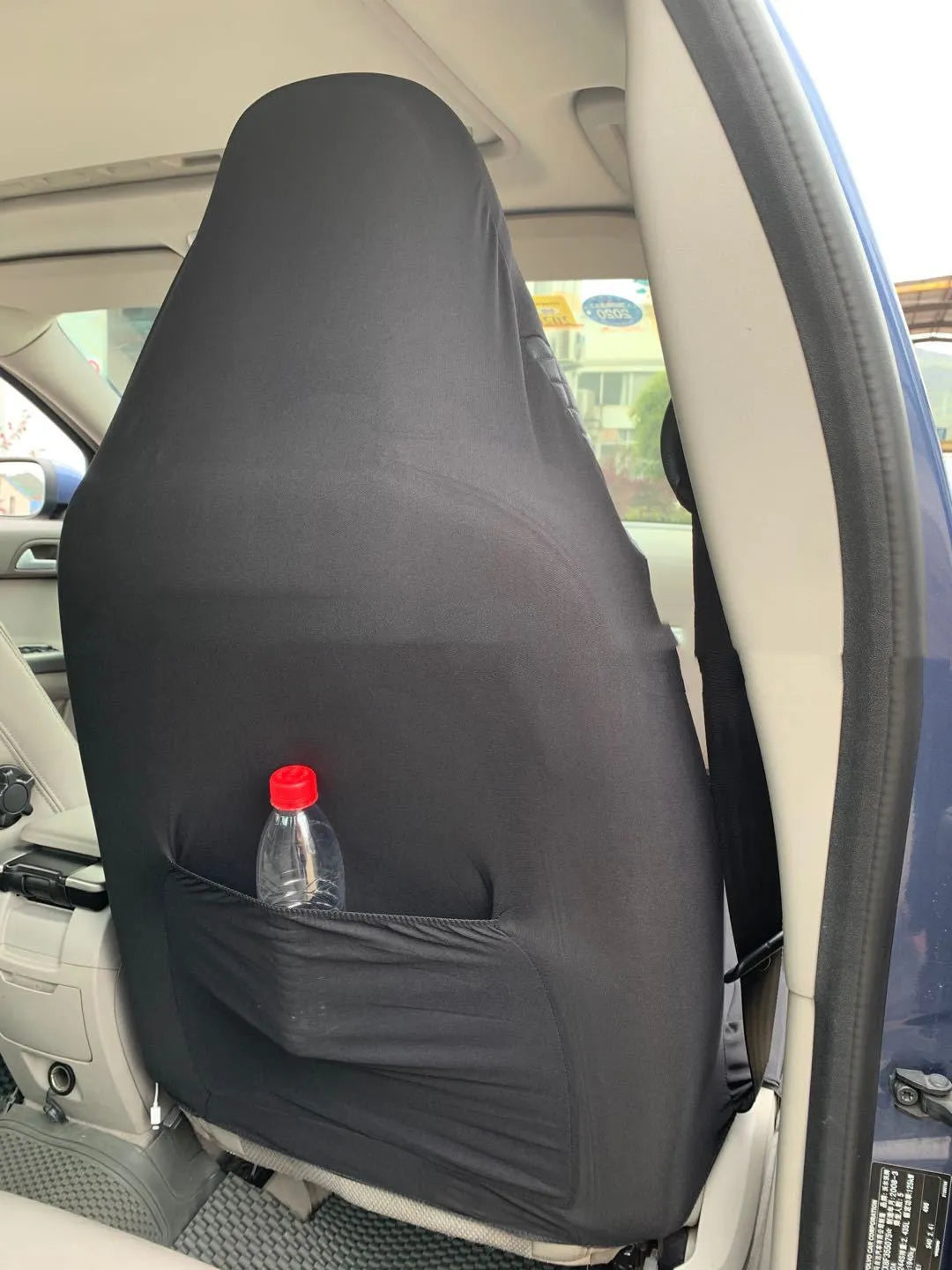 Black quilted automotive seat cover made from PU and polyester fabric with plastic attachment hooks