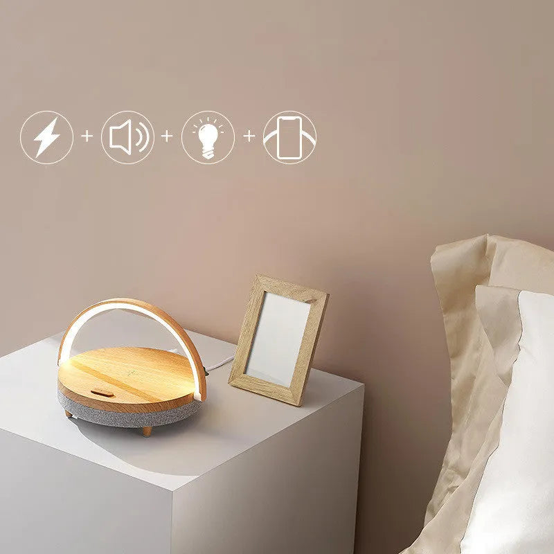Marble pattern wireless charging night light with Bluetooth speaker and integrated phone holder.
