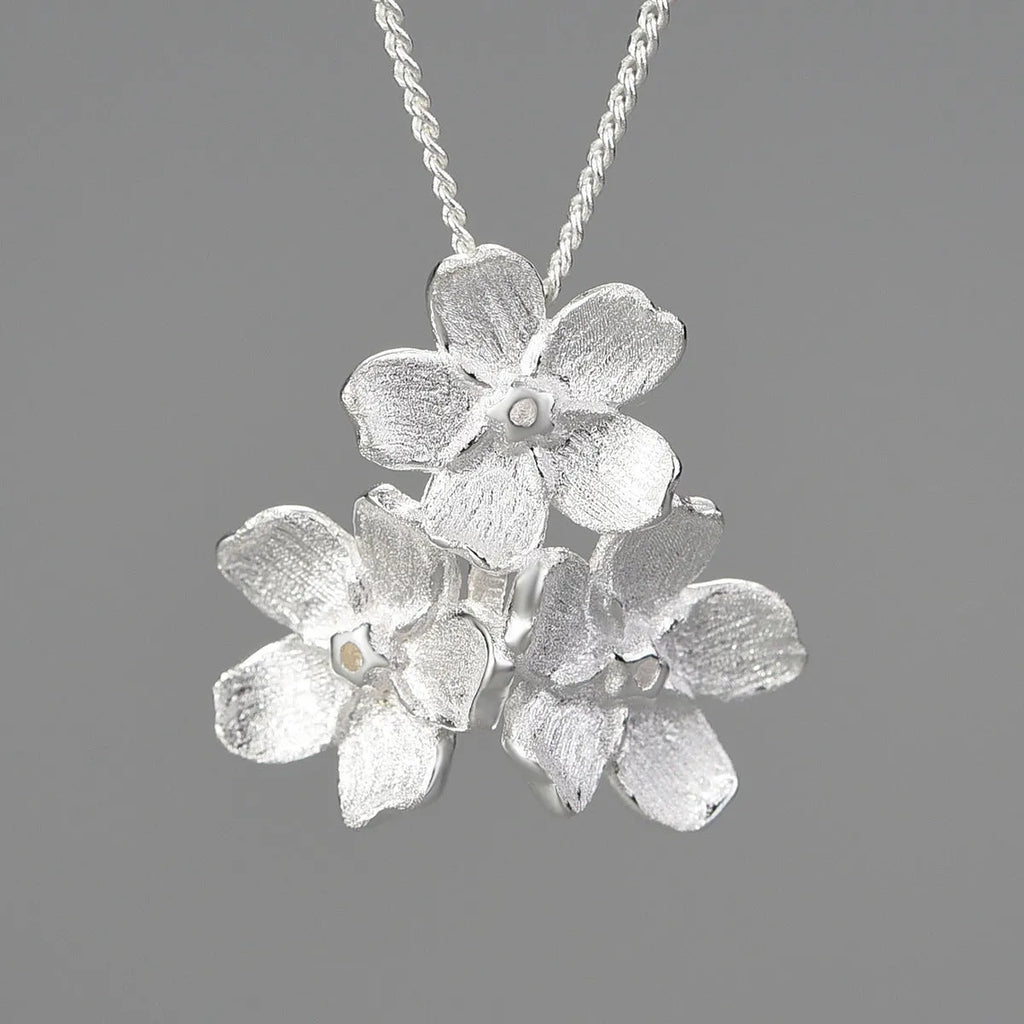 Hand-designed sterling silver Myosotis flower pendant charm with open mouth loop.