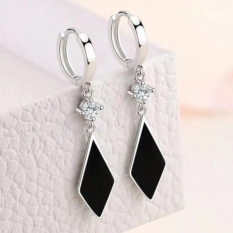 Silver geometric drop ear clip earrings with a vintage diamond pattern.