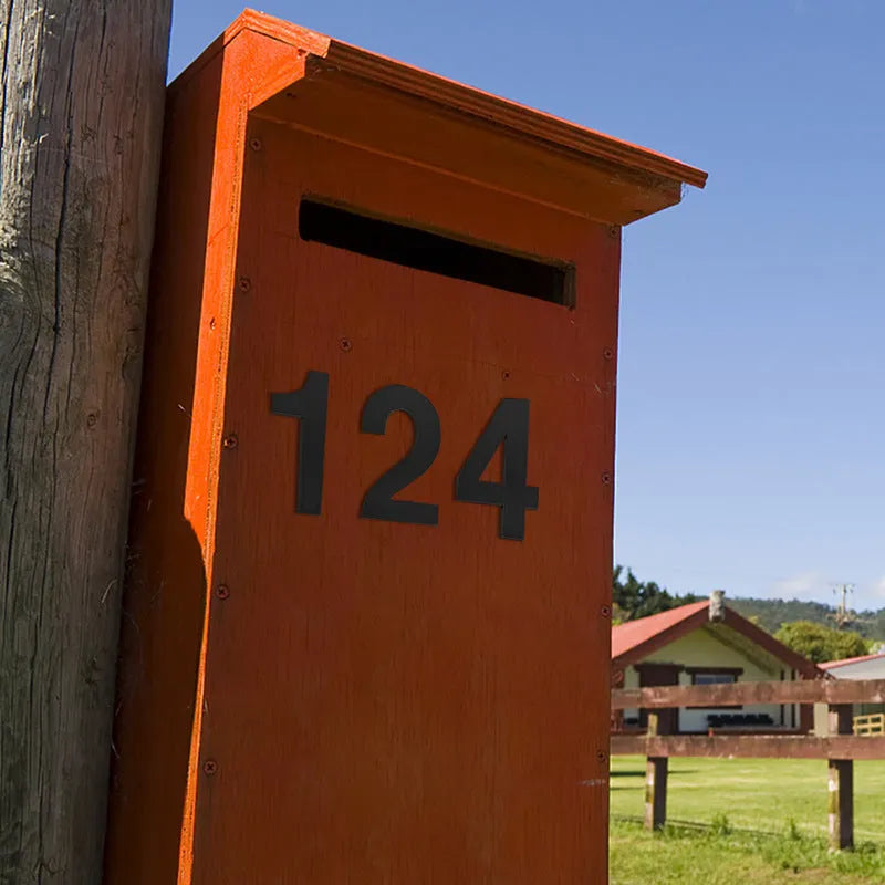 Black stainless steel adhesive-backed house number or letter, 7.5cm tall, for outdoor door or wall.
