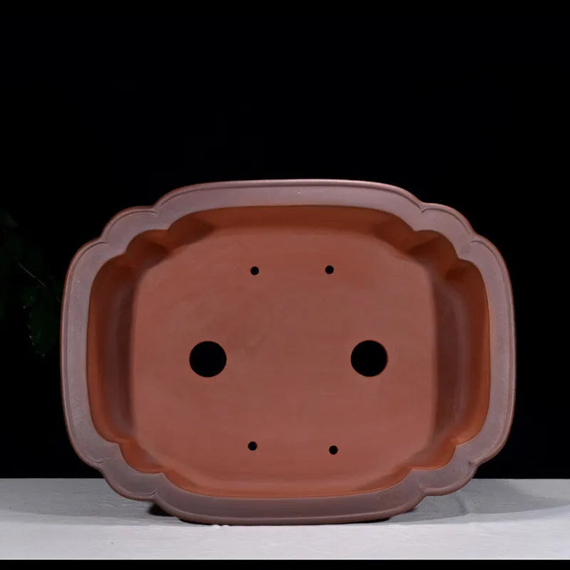 Large antique-style purple clay flowerpot with Chinese design for outdoor garden use.