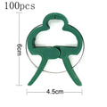 Set of green plastic plant fixing clips with zinc springs, showing large and small sizes for garden use.