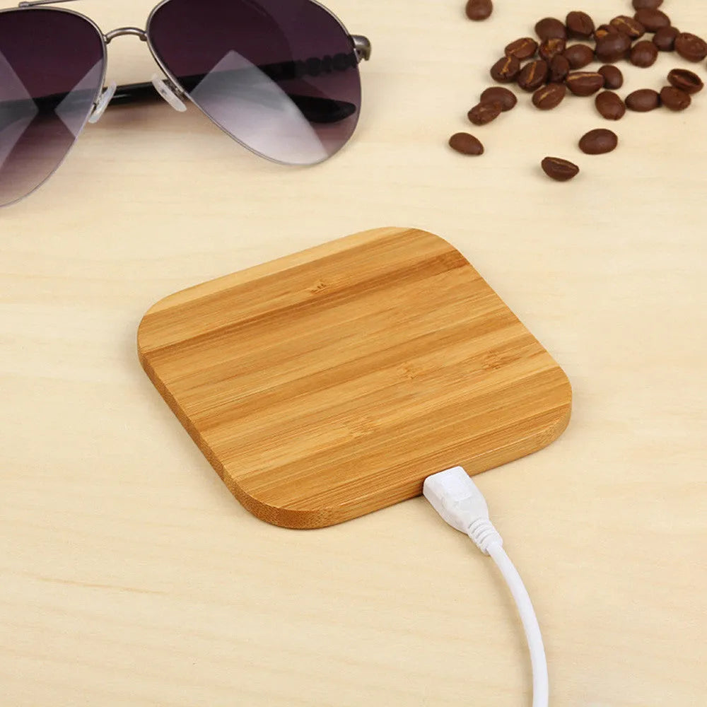 Brown heart-shaped wooden bamboo wireless charger on a table