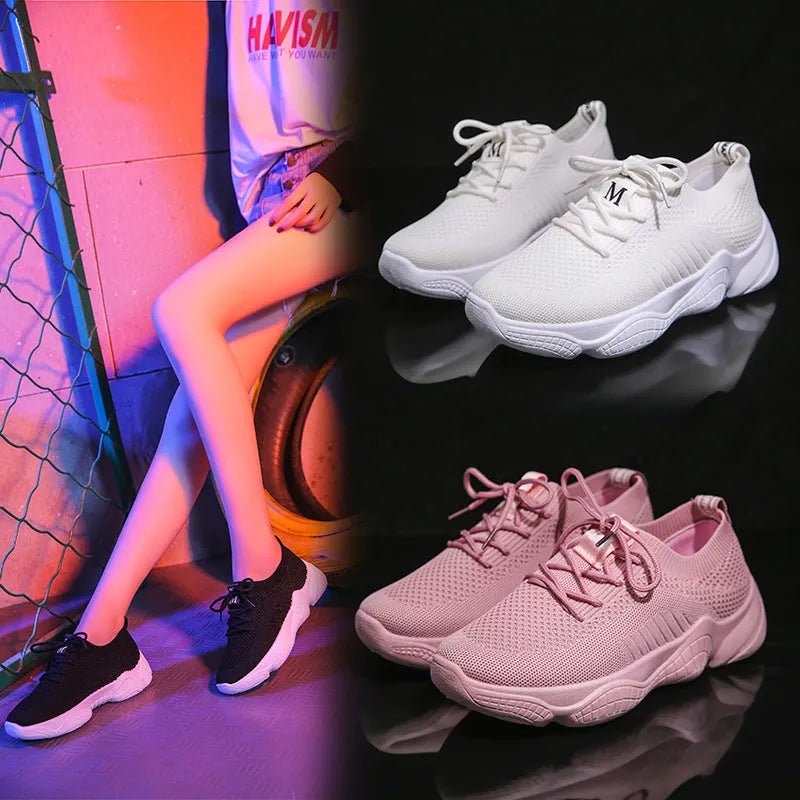 Women's white thick-soled woven trainers with front strap fastening on a plain background.