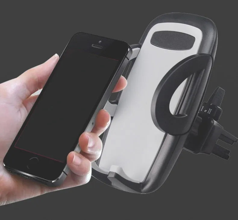 Black car air vent mobile phone holder mounted on vehicle air conditioning outlet holding smartphone