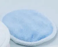 Set of pink and blue velvet makeup remover pads next to an organic cotton drawstring mesh bag.