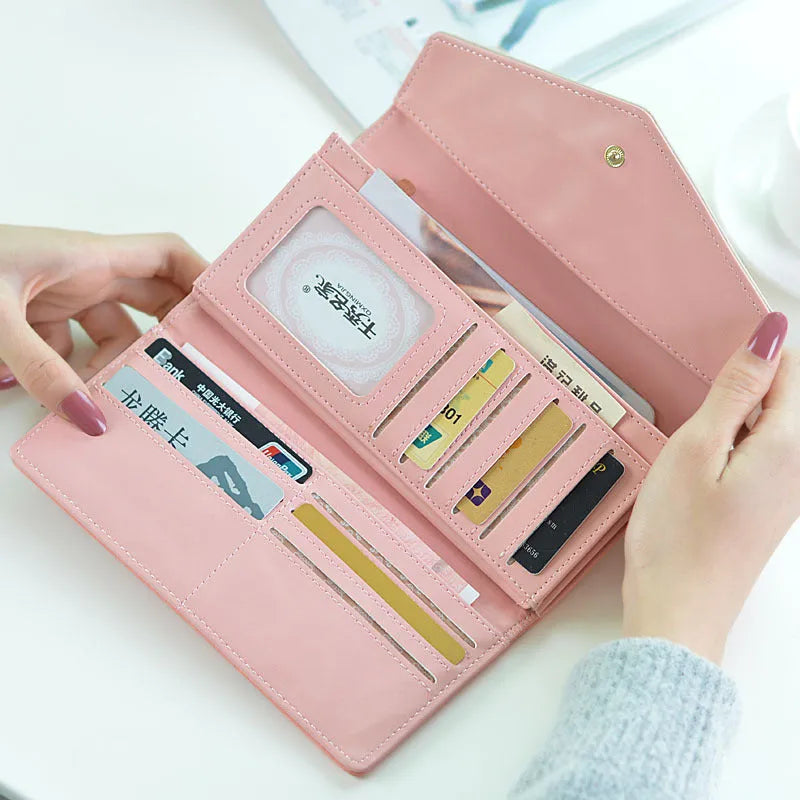 Black PU leather women's wallet with a buckle closure, shown open to reveal a triple-fold design with multiple card slots.
