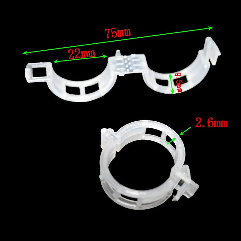 Assorted coloured plastic plant training clips for securing tomato plant branches in the garden.