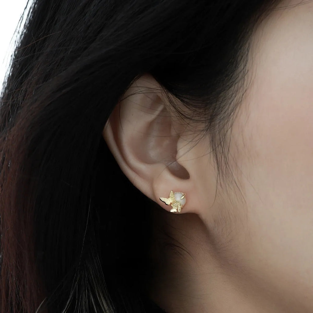 Butterfly ear studs in 925 silver with electroplated gold or white gold finish featuring zodiac modelling