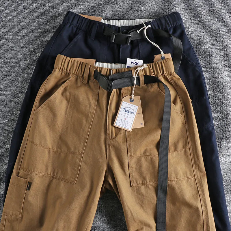 Men's dark blue cotton work trousers with flat front design and straight leg.