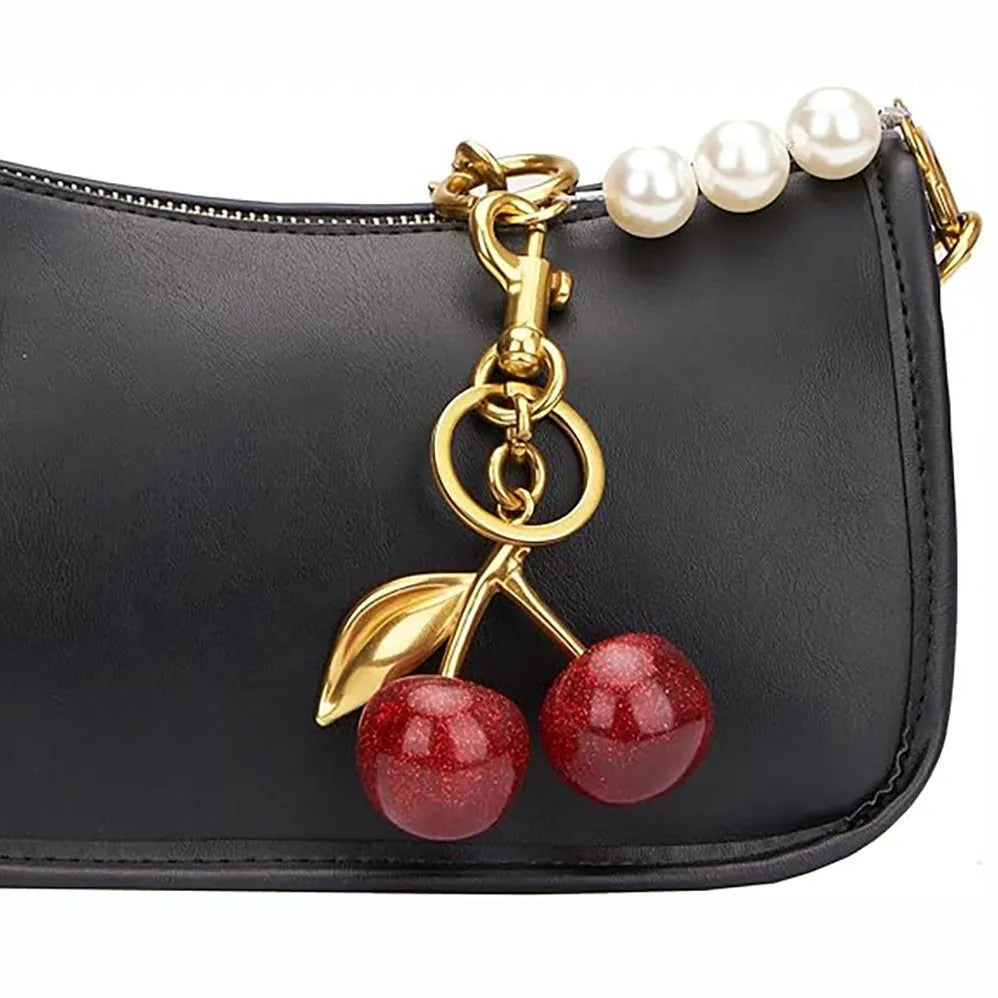 Three-dimensional zinc alloy key ring pendant in pink colour on bag strap