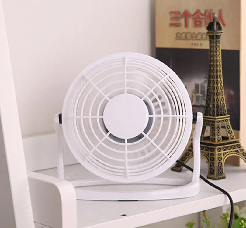 Black mini USB desk fan with adjustable tilt for laptop cooling