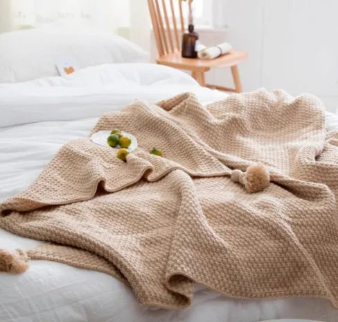 Acrylic knit ball blanket in beige colour, measuring 130 by 170 centimetres, laid flat.