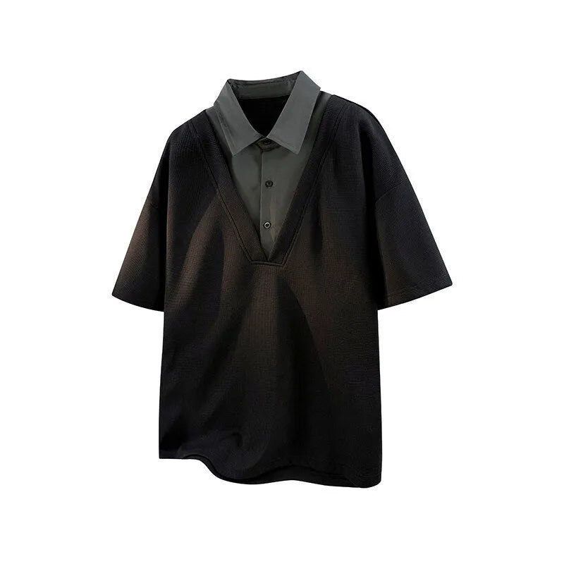 Man wearing a black heavy Henry collar polo shirt sweater with padded shoulders and short sleeves.