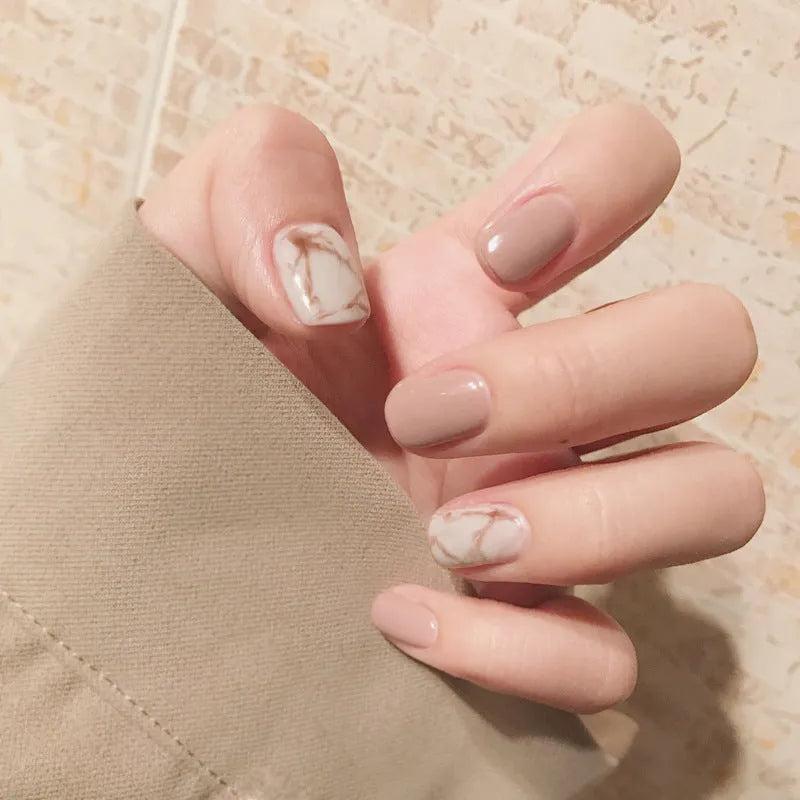 24 light khaki smudge false nails with glue in almond shape on white background