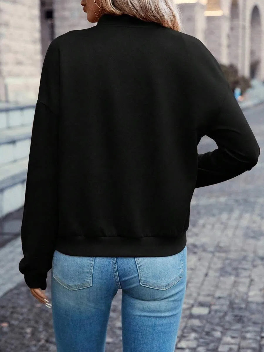 Black women's casual long sleeve zip jacket with faux pocket detailing on a model