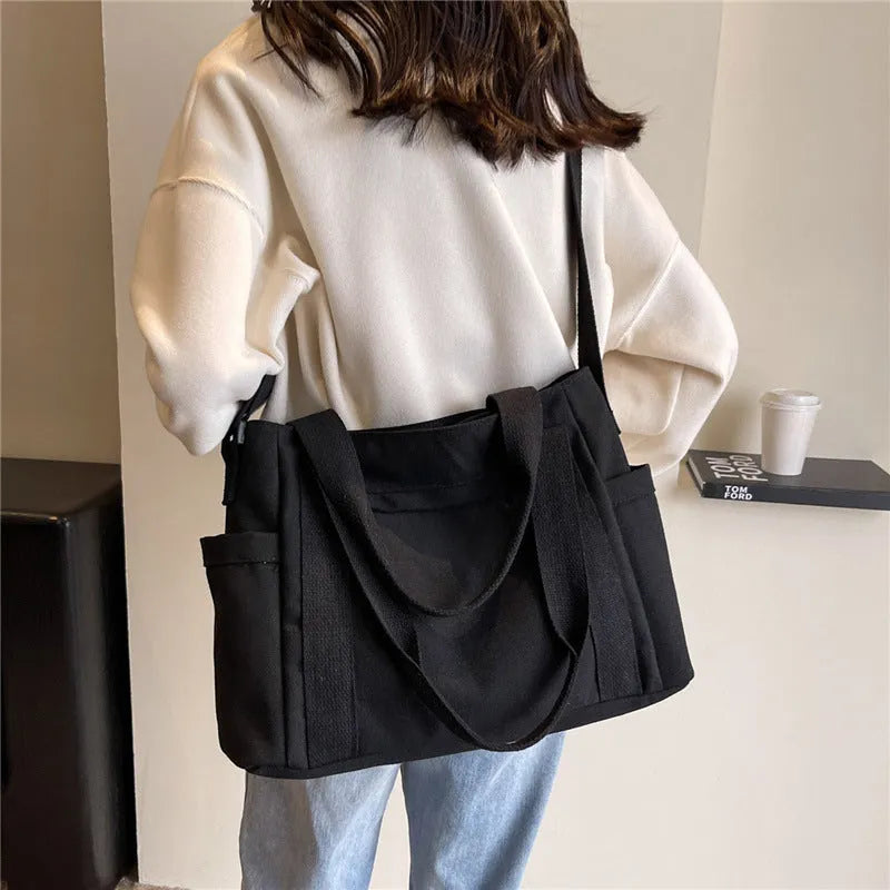 Women's polyester canvas shoulder tote bag in solid colour with exterior sandwich pocket