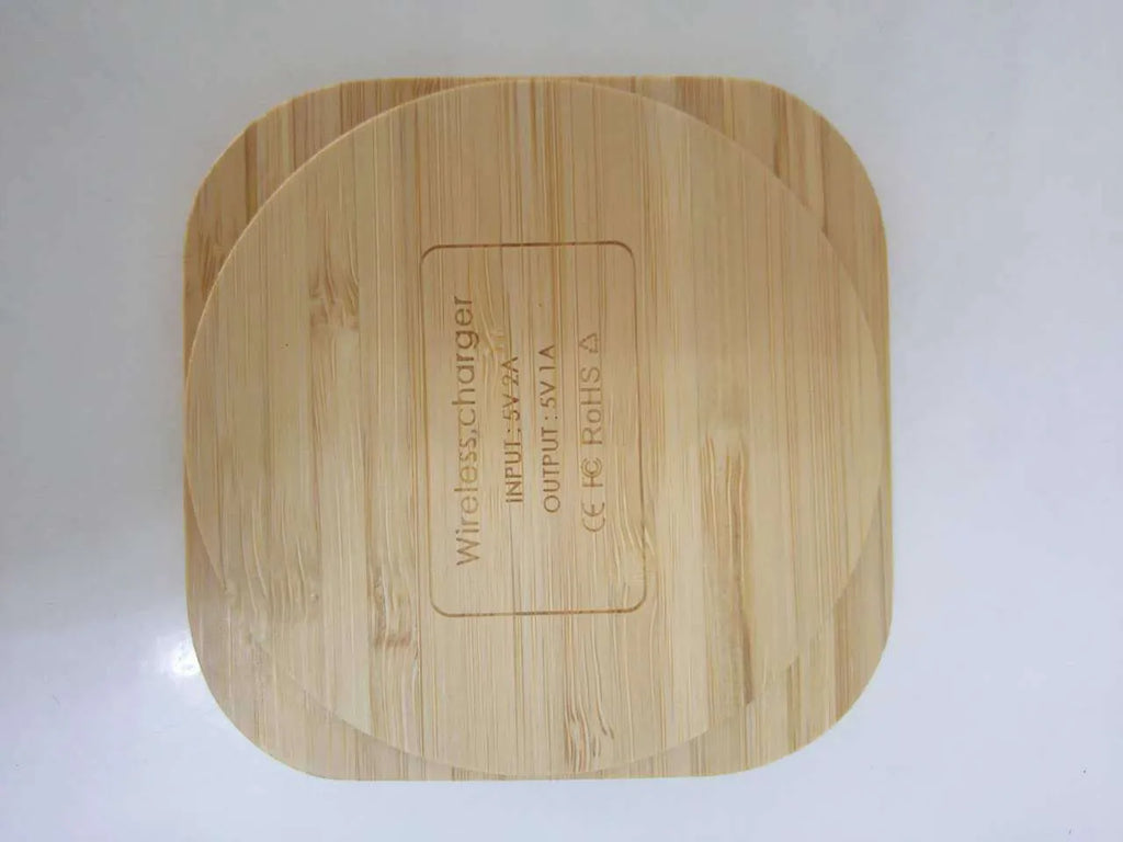 Brown heart-shaped wooden bamboo wireless charger on a table