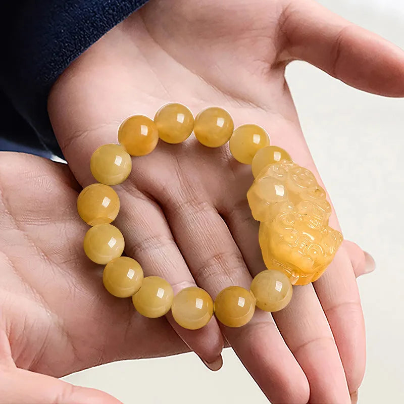 Golden Thread Jinsi Jade carved money bracelet showing pendant and beads, with size option examples.