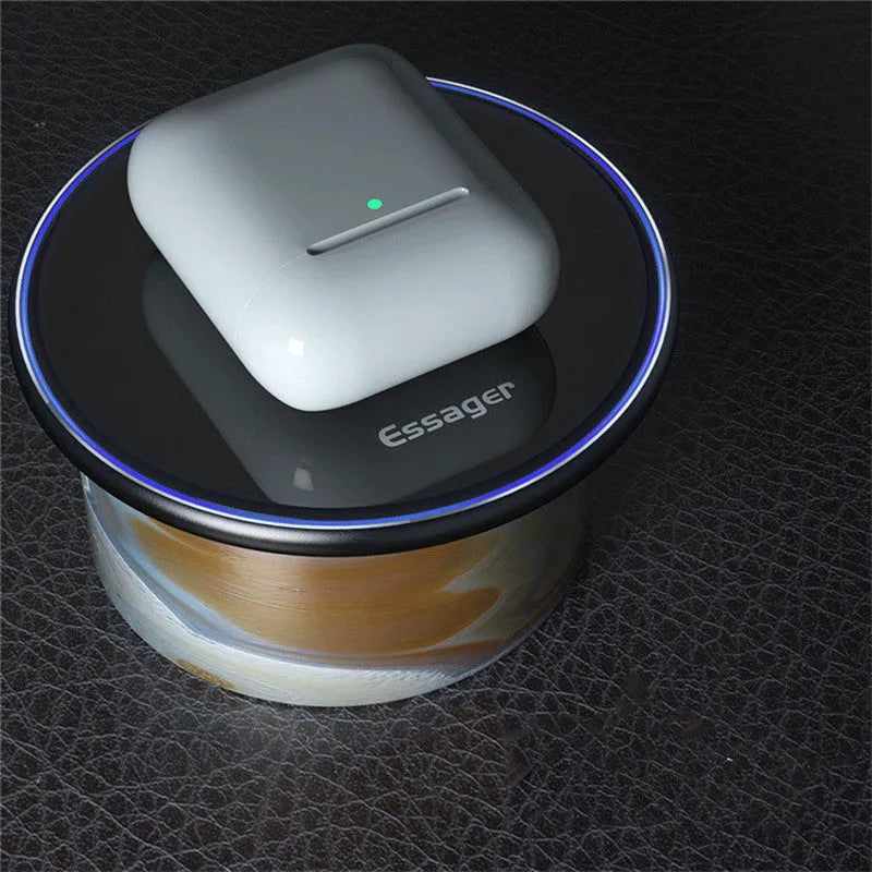 Black 15W Qi wireless charging pad on a wooden surface showing blue LED charging light