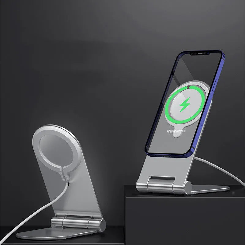 Silver vertical adjustable magnetic phone bracket for iPhone 12 models on a flat surface.
