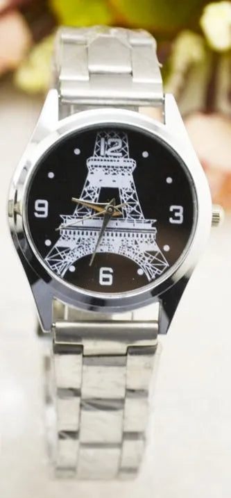 Silver-tone Eiffel Tower analogue wrist watch with black leather strap and roman numeral dial.