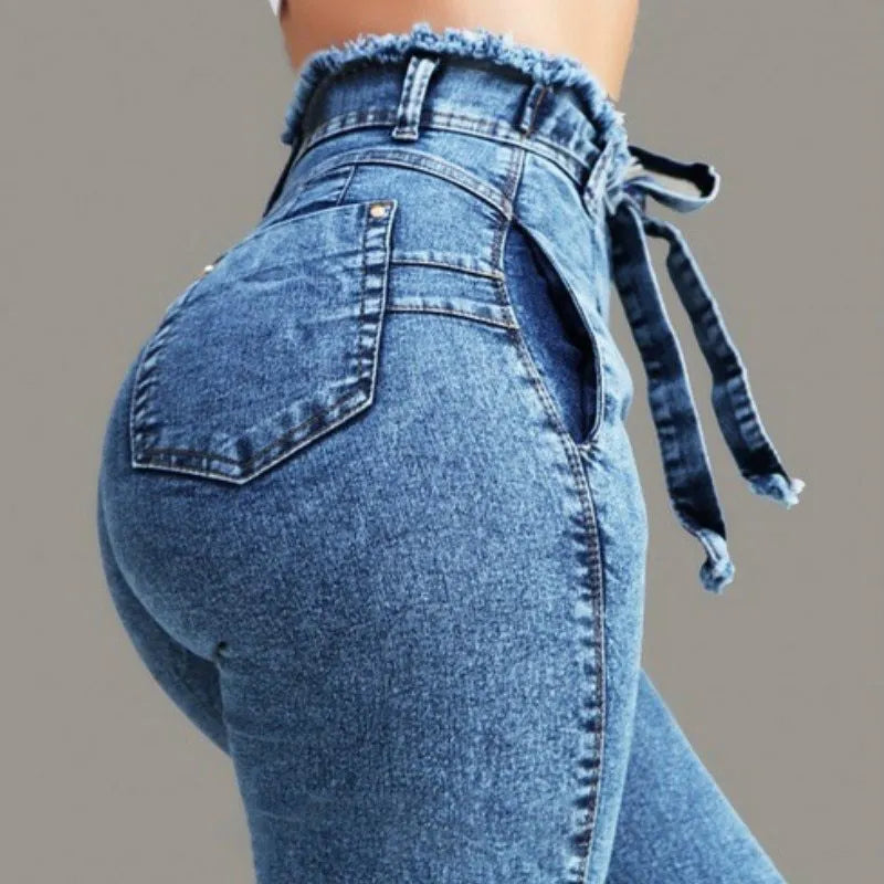 Woman wearing grey fringed straight leg jeans made from cowboy denim fabric.