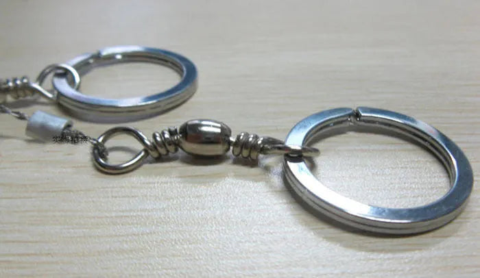 Survival wire saw tool with stainless steel blade and pull rings for outdoor cutting