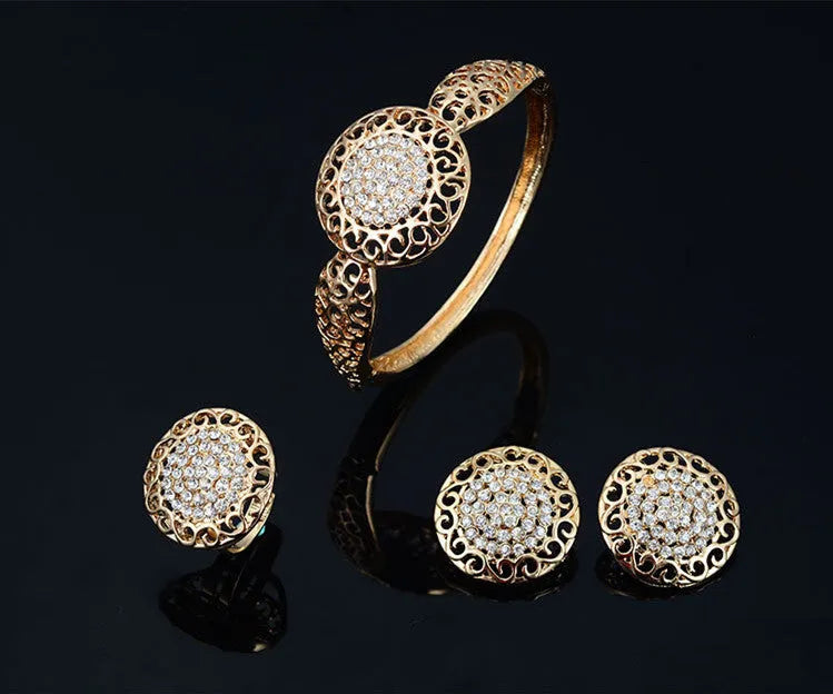 Gold jewellery four piece set with necklace, earrings, ring, and hand accessories featuring alloy and artificial gems