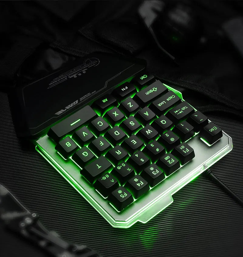 Black robotic one-handed mechanical keyboard with RGB backlighting on a desk