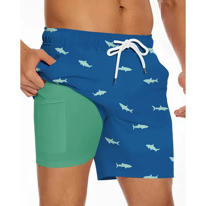 Man wearing loose blue polyester beach shorts on sand, showing relaxed fit and casual style.
