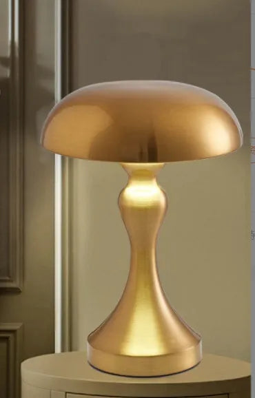 Metallic-finish touch-control LED desk lamp showing three colour light modes on a wooden desk.