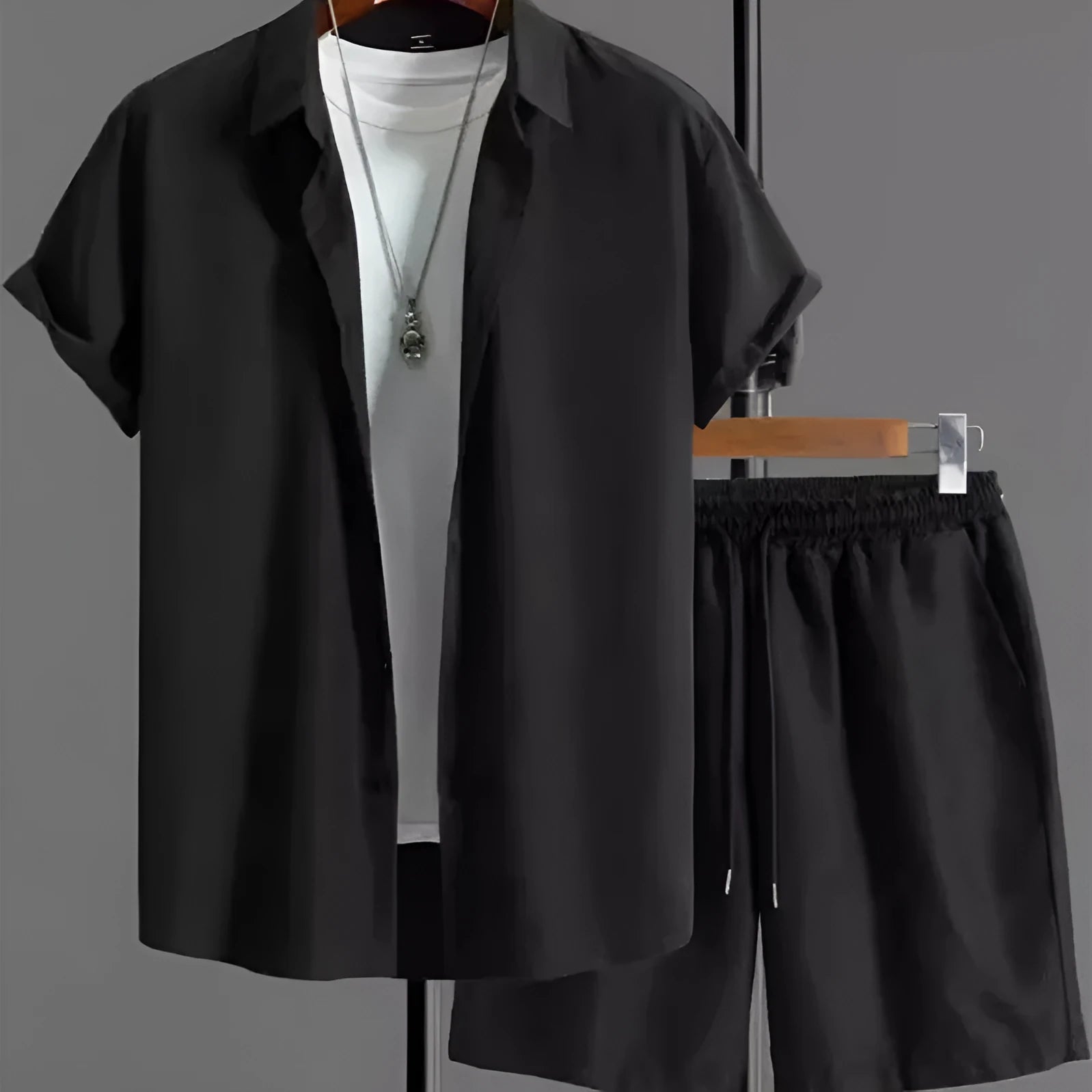 Men's black and white Jacquard print short sleeve suit with matching shorts on a hanger.