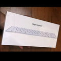 White Apple G6 ultra-thin aluminium Bluetooth wireless keyboard on a desk.