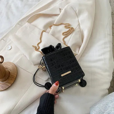 Small black PU leather one shoulder messenger bucket bag with a single chain strap.