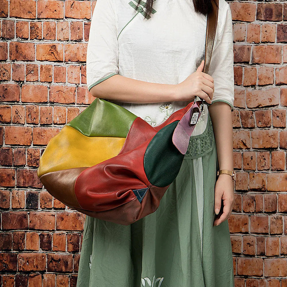Cowhide leather crossbody travel bag showing stitching detail and 48cm dimensions