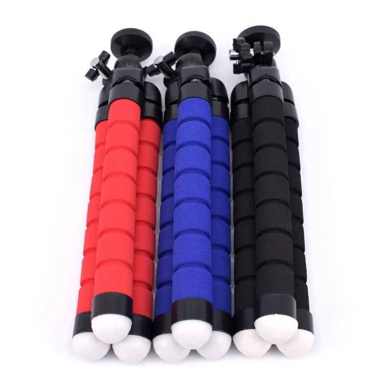 Black flexible octopus tripod with wrapped legs next to a smartphone