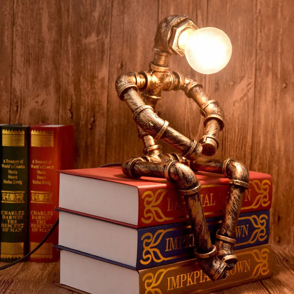Green bronze industrial desk lamp with iron pipe design on wooden table