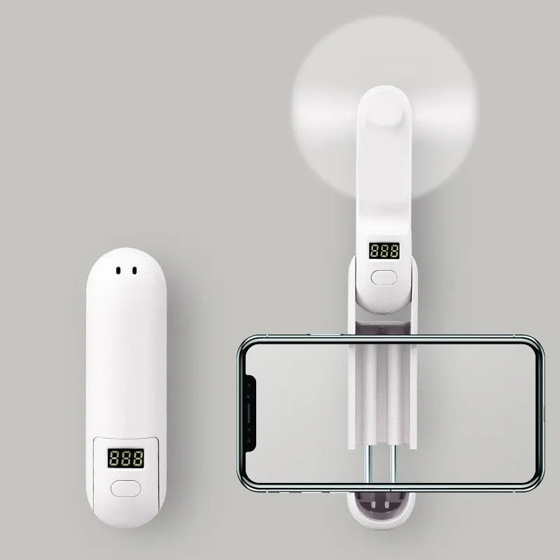 Folding mini personal desk fan showing three plastic blades and compact housing
