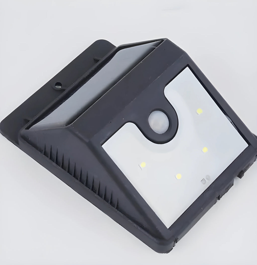 Pack of four white outdoor solar LED sensor lights for garden pathways.