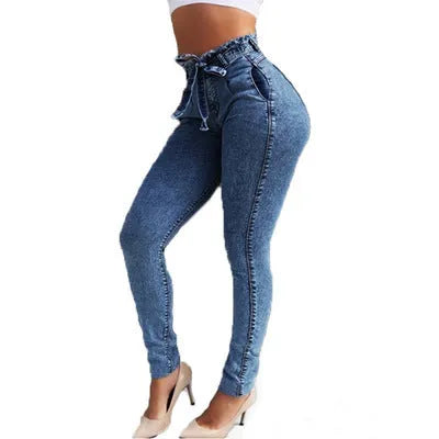 Woman wearing grey fringed straight leg jeans made from cowboy denim fabric.