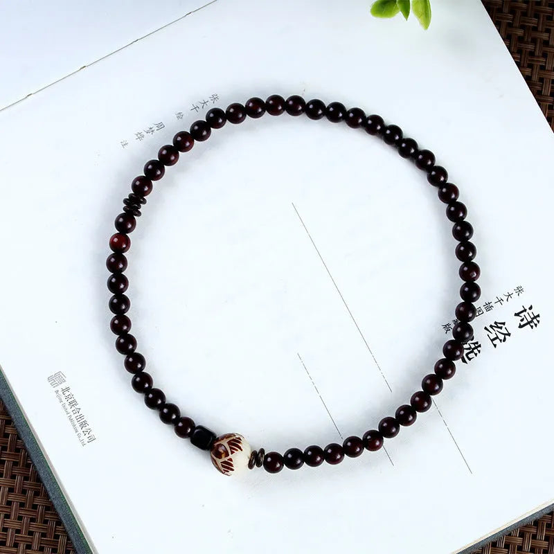 Natural rosewood knitted unisex bracelet with 10mm flower-shaped beads double circle on white background
