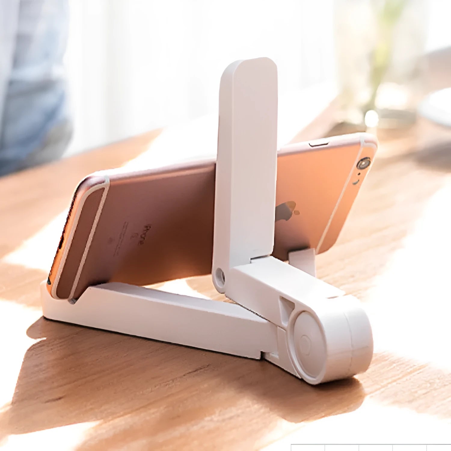 Black foldable tablet holder showing adjustable stand supporting smartphone in landscape orientation