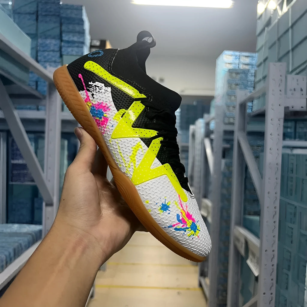 Adult low-top football boots with a PVC upper and rubber studded outsole, shown in black and yellow.