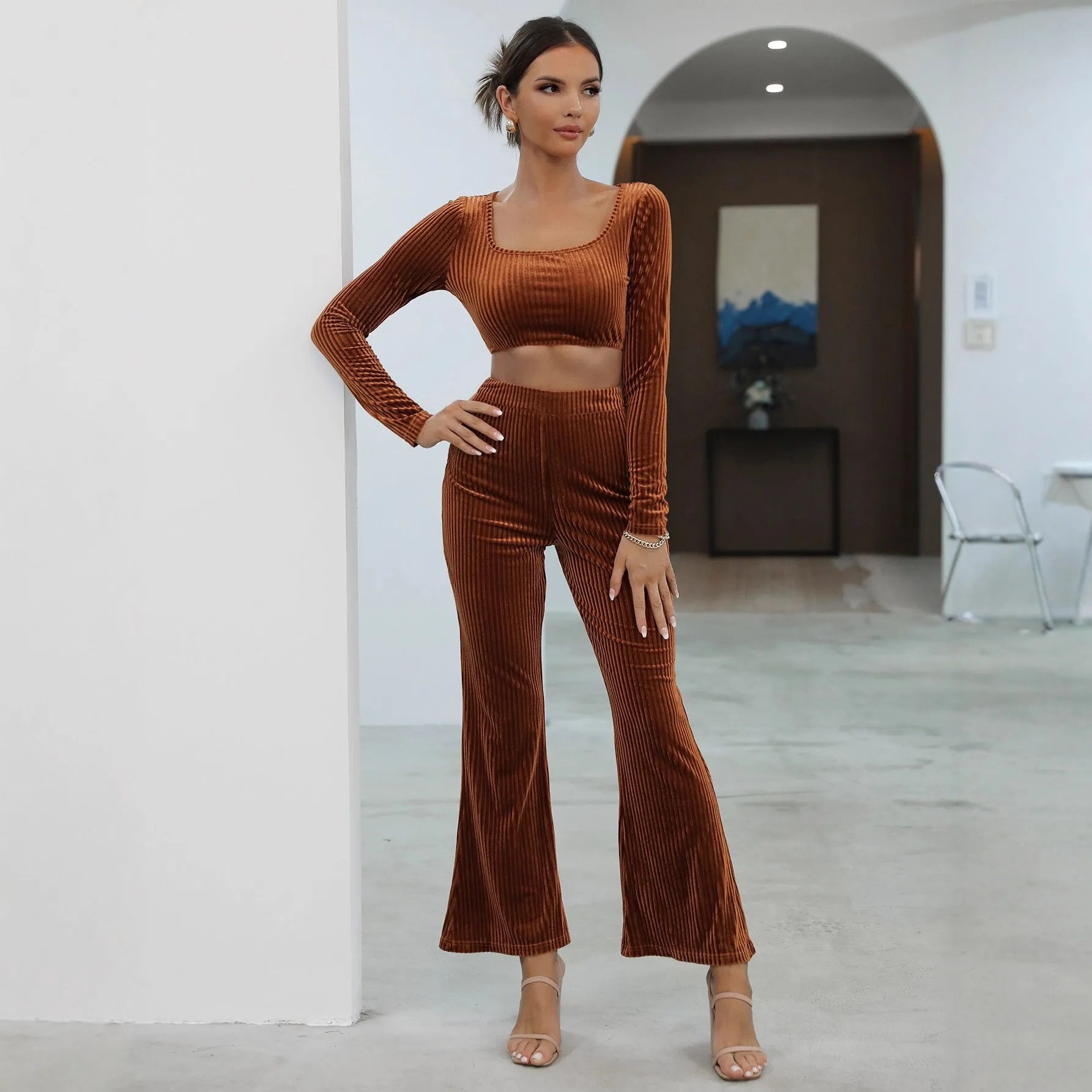 Caramel coloured long sleeve sweater and matching trousers loungewear set on a hanger